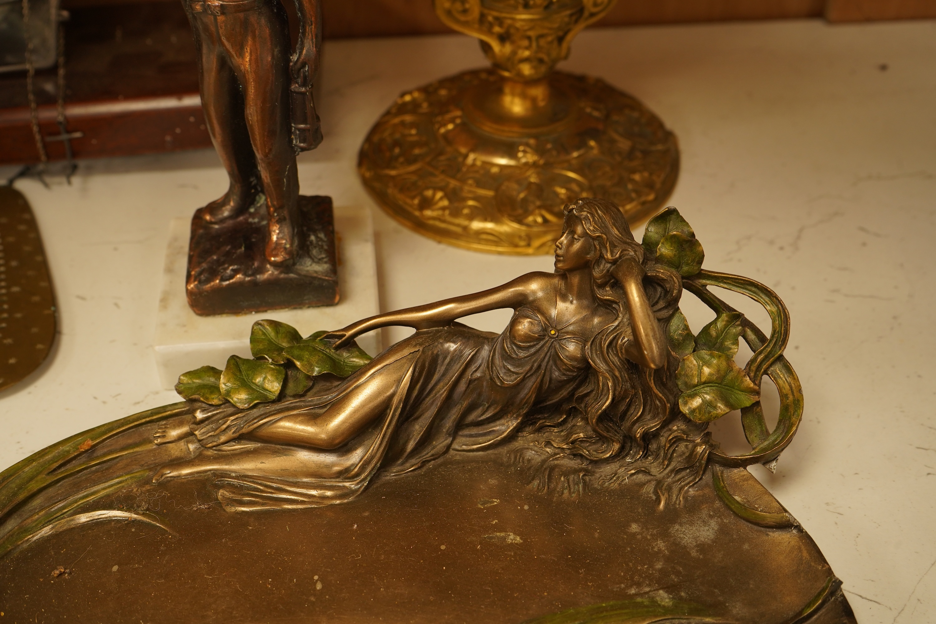 A mixed group of metalware including an Art Nouveau figural dish and pewter dish, a candlestick etc